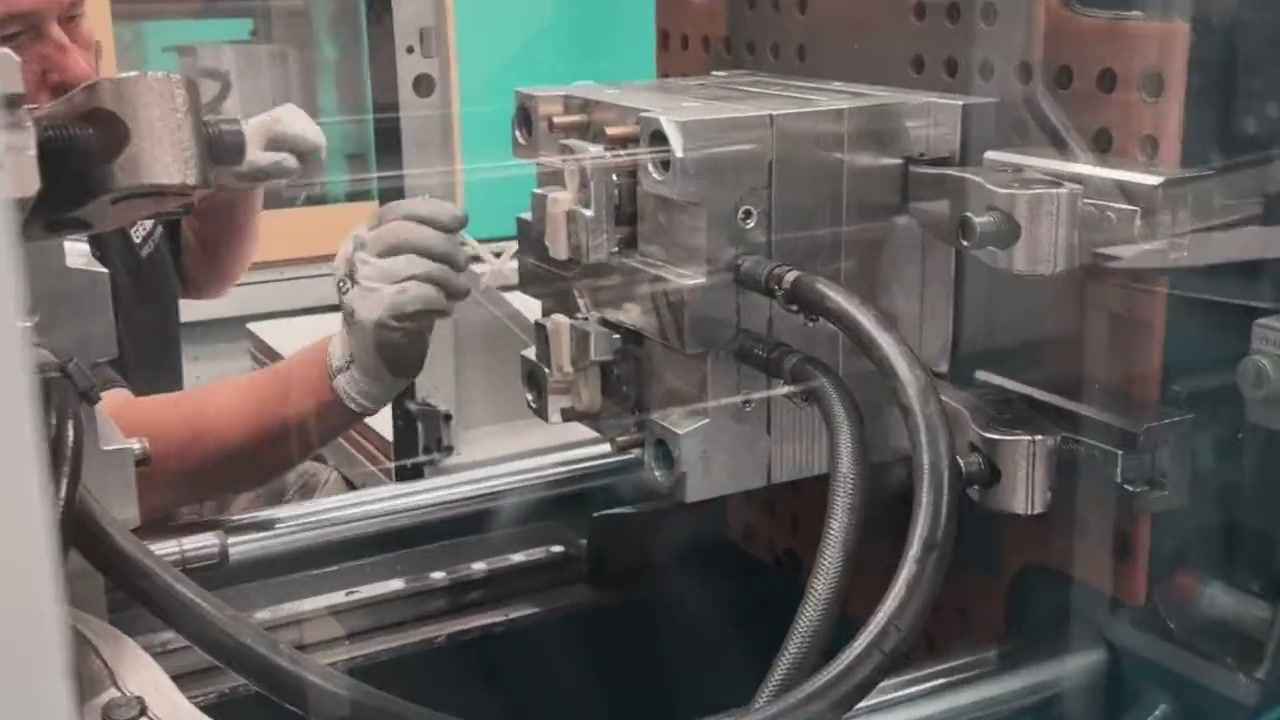 An engineer removing a moulded part from an injection moulding tool at Gemini
