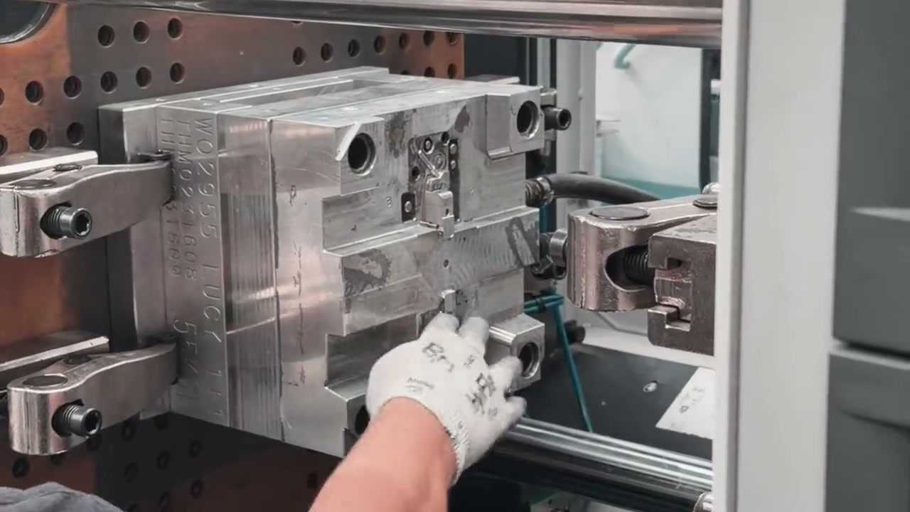An engineer loading an injection mould tool into an injection moulding machine at Gemini